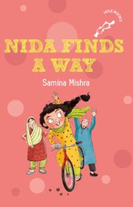 Book cover
Text: Nida Finds a Way
Samina Mishra
HOLE BOOKS
Image:
Illustration of a girl waving as she cycles away from a worried couple